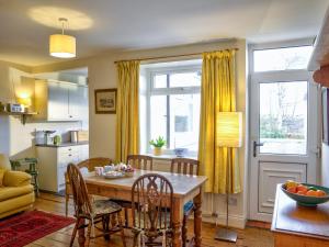 a kitchen and dining room with a table and chairs at The Nook in Alnwick