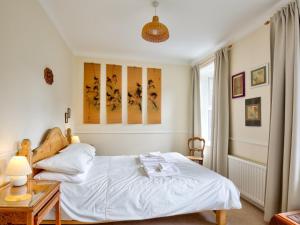 a bedroom with a bed and a table and a window at The Nook in Alnwick