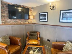 a waiting room with two chairs and a flat screen tv at The Scotch Arms Mews - Uk30910 in Brampton