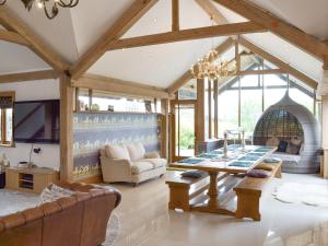 a living room with a table and a fireplace at Carr End Barn A in Preesall