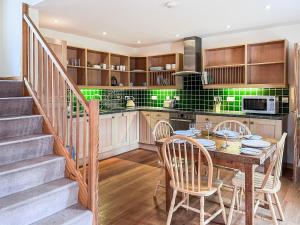 a kitchen and dining room with a table and chairs at The Old Post Office in Arnisdale