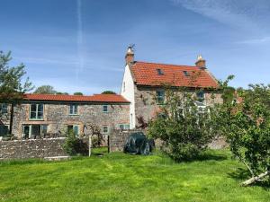 an old stone house with a yard in front of it at Lake View-uk34414 in Cheddar