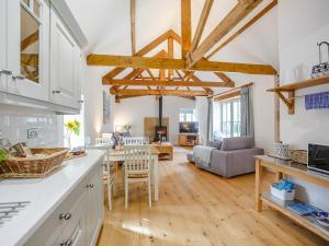 a kitchen and living room with wooden beams at The Stable - Uk35021 in Long Houghton