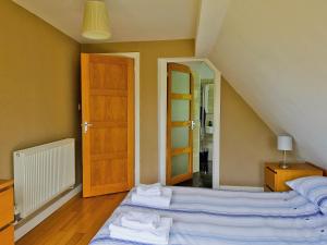 a bedroom with a bed with towels on it at Still Waters in Wroxham