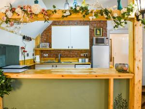 a kitchen with a counter and a refrigerator at Lower West in Newnham