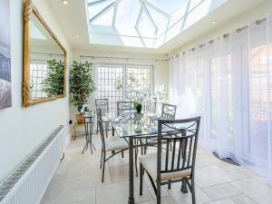 a dining room with a glass table and chairs at South Cliff in Bessingby