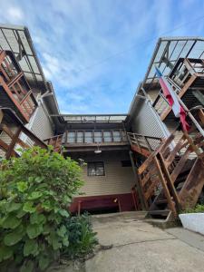 a house with a spiral staircase in front of it at Deptos Guacolda in Algarrobo