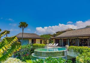 an exterior view of a house with a swimming pool at Villa Cantik Pandawa By Fays Hospitality in Ungasan