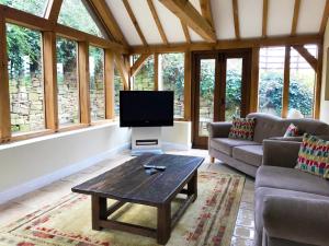 a living room with a tv and a table at Brankley Cottage - E4712 in Dunstall