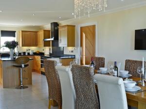 a kitchen and dining room with a table and chairs at Wheatfield House in Kilmaurs