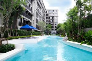 a swimming pool in a resort with a water slide at The Marvest Hua Hin in Hua Hin