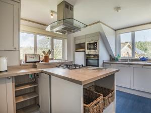 a kitchen with a large island with a counter top at Clock Cottage in Branscombe