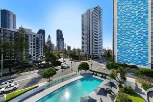 a pool in the middle of a city with tall buildings at Beautiful Ocean View High Floor 3 Bedroom Apartment at Sierra Grand in Gold Coast
