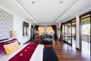 a bedroom with a bed and a living room at Villa Manis Canggu in Canggu