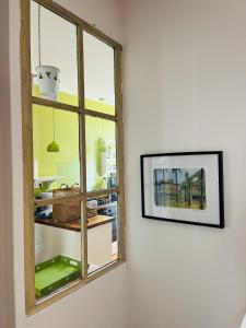 a room with a window and a picture on a wall at La Yonnaise in La Roche-sur-Yon