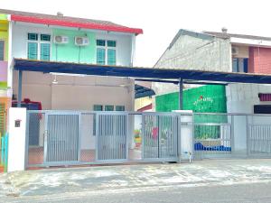a white gate in front of a building at Happy Gather Homestay 欢聚阁 in Ipoh