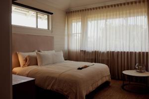 a bedroom with a large bed and a window at 28 Degrees Byron Bay - Adults Only in Byron Bay