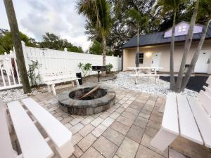 a patio with two benches and a fire pit at 2 Q Studio Apt With Shared Pool 510 in Clearwater