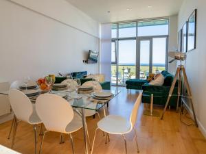 a living room with a dining room table and chairs at Penthouse 47 Zinc in Newquay