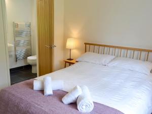 a bedroom with a bed with two towels on it at The Perch-uk12929 in St. Just