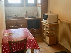 a small kitchen with a table and a microwave at Appartement Les Gets, 1 pièce, 3 personnes - FR-1-671-129 in Les Gets