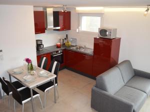 a living room with a table and a couch and a kitchen at Gîte familial tout confort à Altkirch - Terrasse, jardin, parking, proche pistes cyclables et randos - FR-1-744-5 in Altkirch