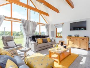 a living room with a couch and a table at Sunnyside House in Duthil