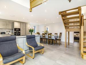 a kitchen and dining room with a table and chairs at Fenside Way in Wicken