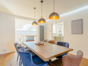 a dining room with a wooden table and chairs at Carmel in Whitby