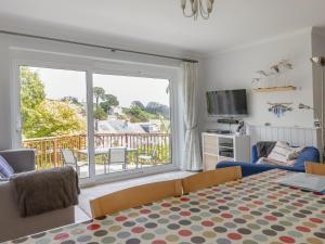 a living room with a bed and a large window at Rockvale 1 in Salcombe