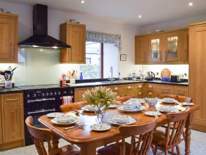 a kitchen with a wooden table with chairs around it at Tigh Na Bruaich in Kenmore