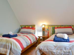 a bedroom with two beds with towels on them at ow Do - Uk11446 in Skipsea