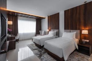 Ένα ή περισσότερα κρεβάτια σε δωμάτιο στο Forest Hills Hotel