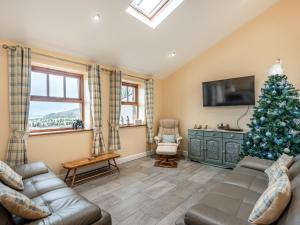 a living room with a christmas tree and a couch at Seascape in Holyhead