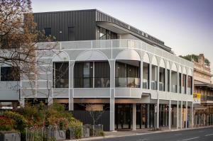 a large white building on the side of a street at Grow at Goodwood in Adelaide