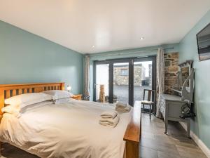 a bedroom with a large bed and a television at Seascape in Holyhead