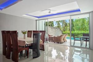 comedor con mesa y sillas en 4 bedrooms & bathroom for up to 12 guests 7kms to Patong beach at The Fairways golf villas en Phuket