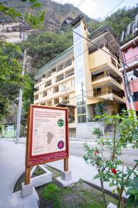 a sign is in front of a building at Santuario Machupicchu in Machu Picchu