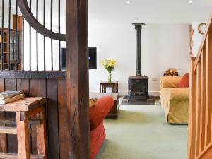 a living room with a wood stove in it at Fair Maid in Kentisbeare