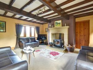 a living room with a couch and a fireplace at Lane House in Threshfield