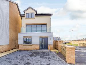 a house with a glass door in a street at Coastal Retreat in Amble