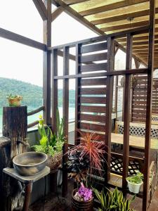 a pergola with plants and a bowl on a patio at Cherry Feast Resort in Yuchi