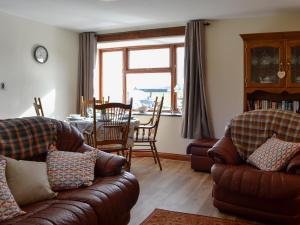 a living room with two couches and a dining room at Trefechan in Pumpsaint