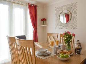 a dining room table with a plate of food on it at Britannia Way in Westward Ho
