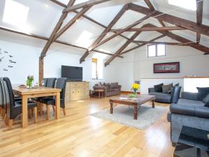 a living room with a table and a couch at The Cow Shed in Tiverton