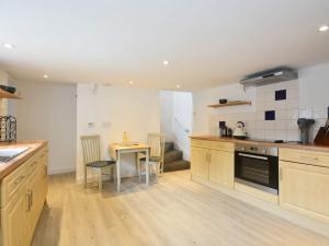 a kitchen with a table and a dining room at Hawkes Lane in Canterbury