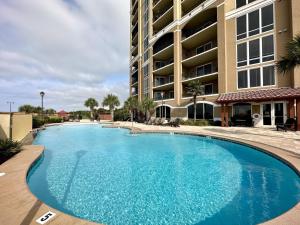 a large swimming pool in front of a building at Lovely 22 In Sienna Overlooking The Gulf in Gulfport