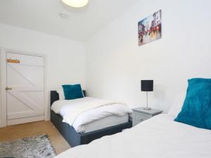 a bedroom with two beds and a door in it at Hawkes Lane in Canterbury