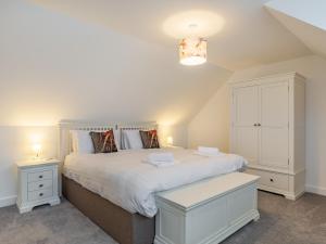 a bedroom with a large white bed with two night stands at Broadacre House in Brixham