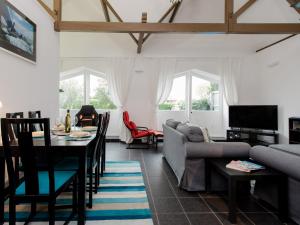a living room with a couch and a table at The Boathouse in East Cowes